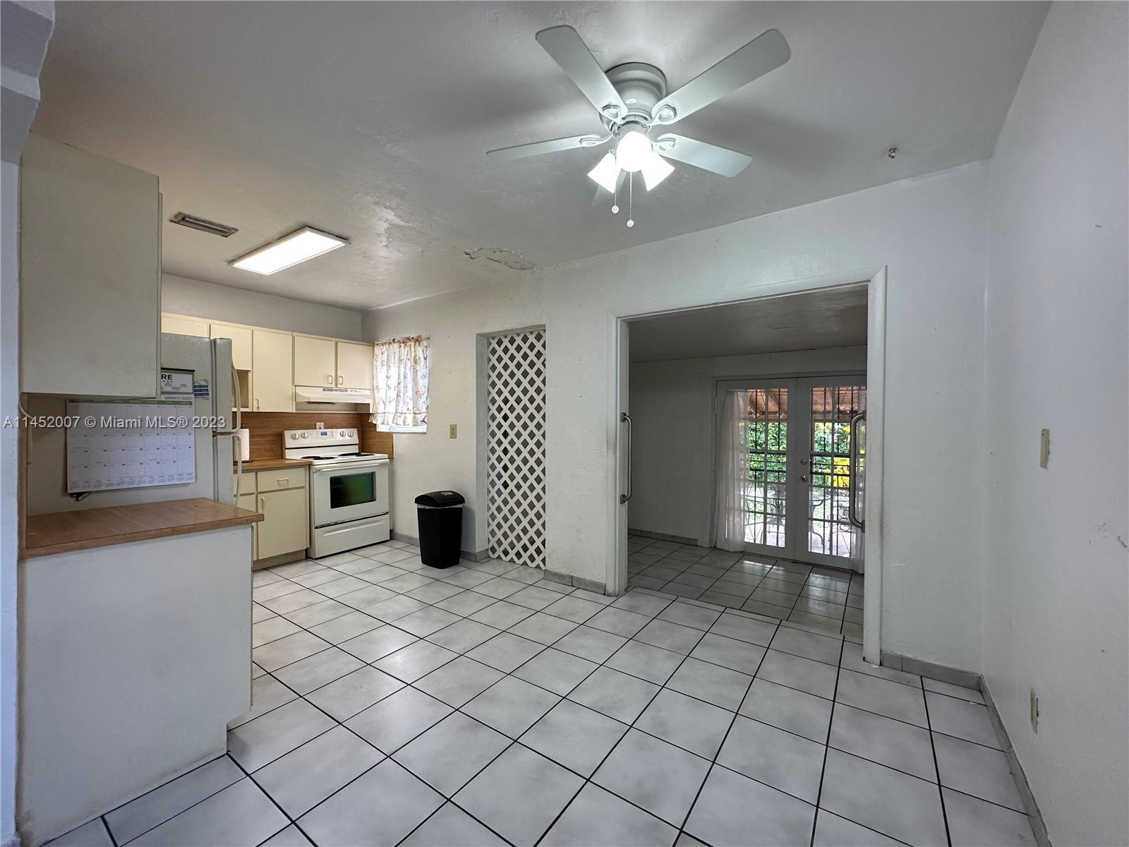 West Flagler Miami, FL 33135 - Photo 17 of 46 a kitchen with stainless steel appliances granite countertop a refrigerator and a sink