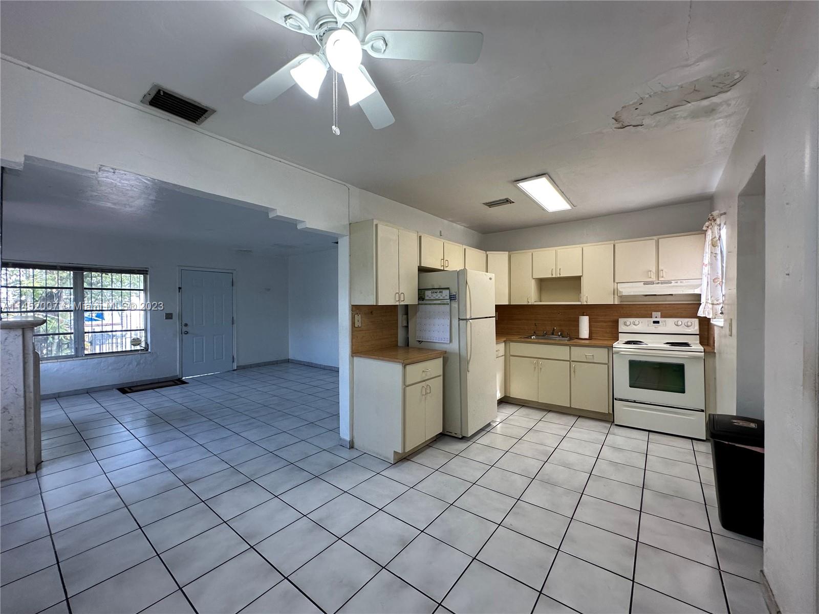 West Flagler Miami, FL 33135 - Photo 18 of 46 a kitchen with a stove cabinets and counter space