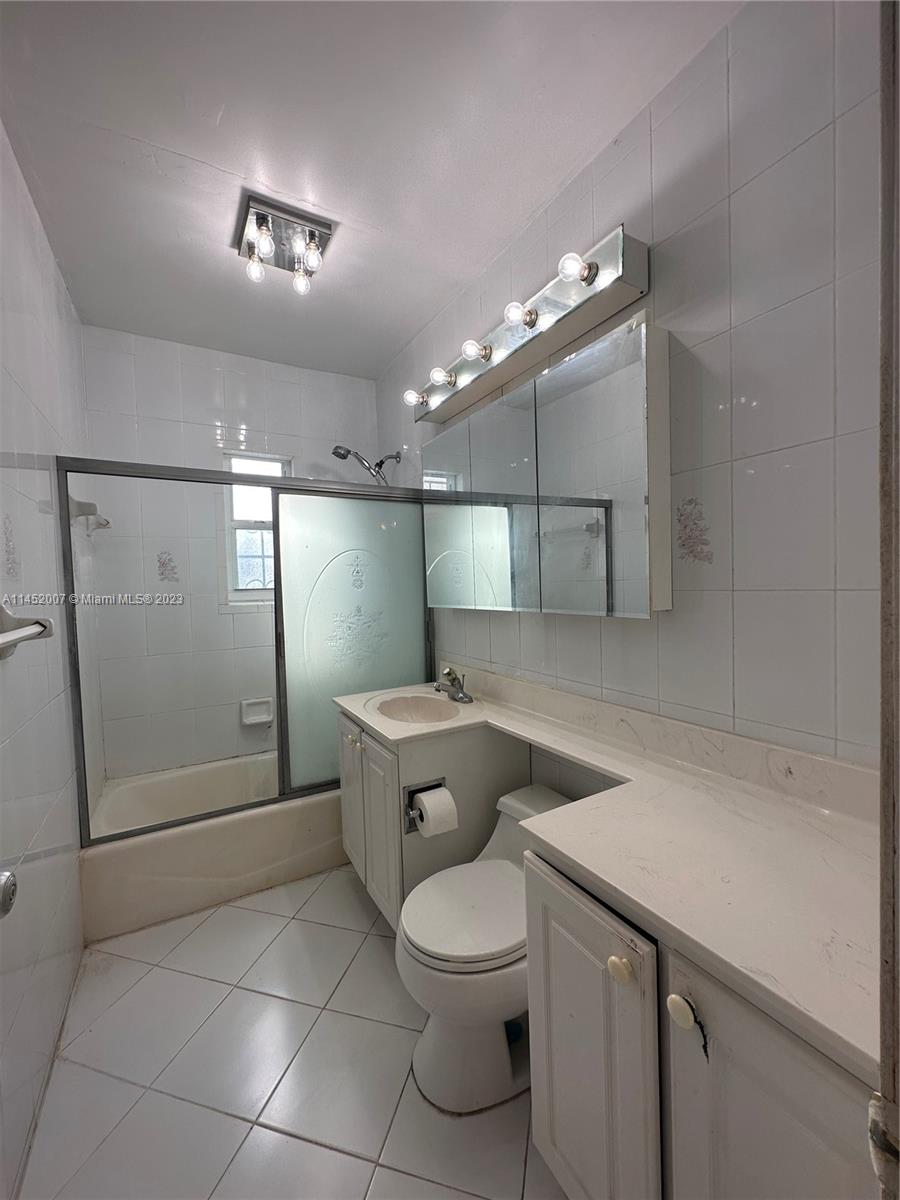 West Flagler Miami, FL 33135 - Photo 35 of 46 a bathroom with a toilet a sink and mirror