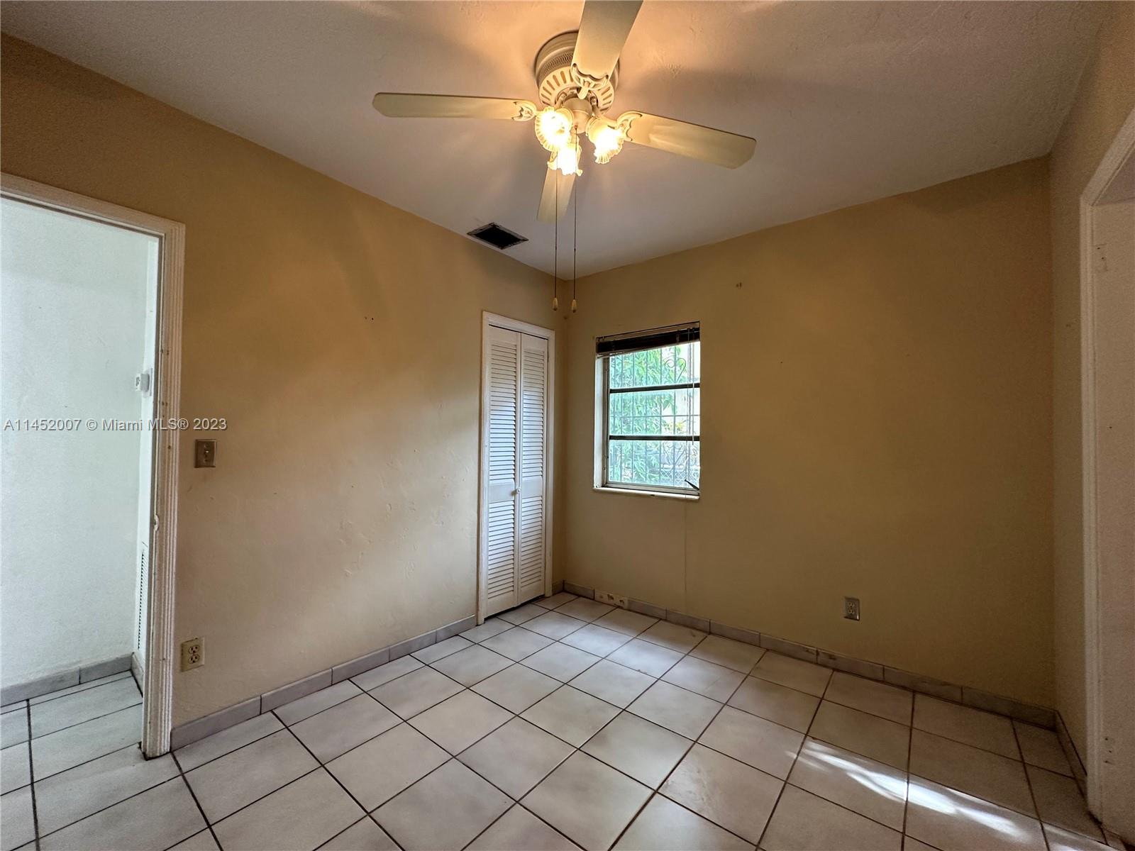West Flagler Miami, FL 33135 - Photo 38 of 46 a view of an empty room with window and chandelier fan