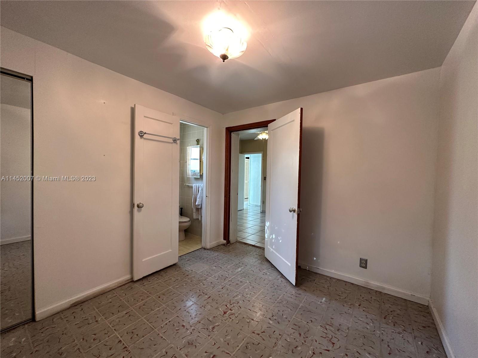 West Flagler Miami, FL 33135 - Photo 43 of 46 an empty room with closet and wooden door