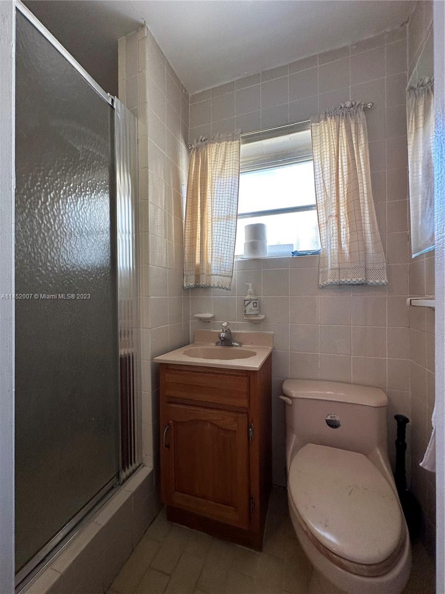 West Flagler Miami, FL 33135 - Photo 45 of 46 a bathroom with a toilet a sink and a mirror