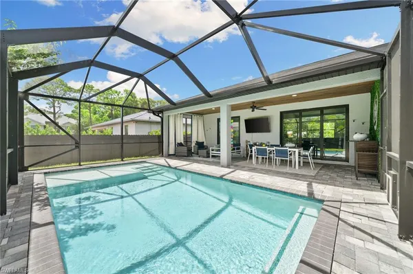 a view of a swimming pool with outdoor seating