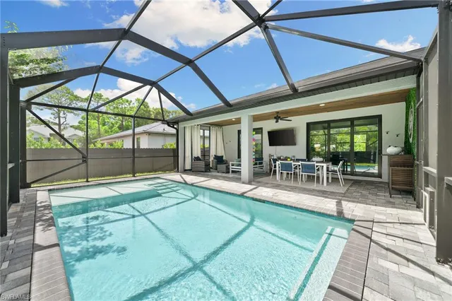 a view of a swimming pool with outdoor seating