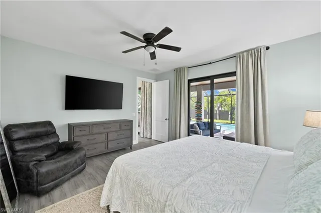 a bedroom with a bed couch and a flat screen tv