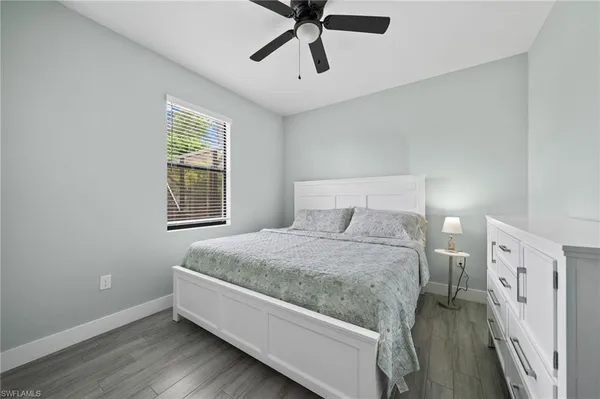 a spacious bedroom with a bed and a window