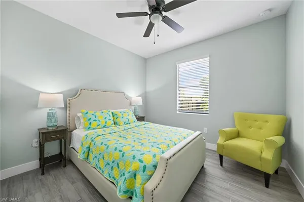 a bedroom with a bed a couch and a window