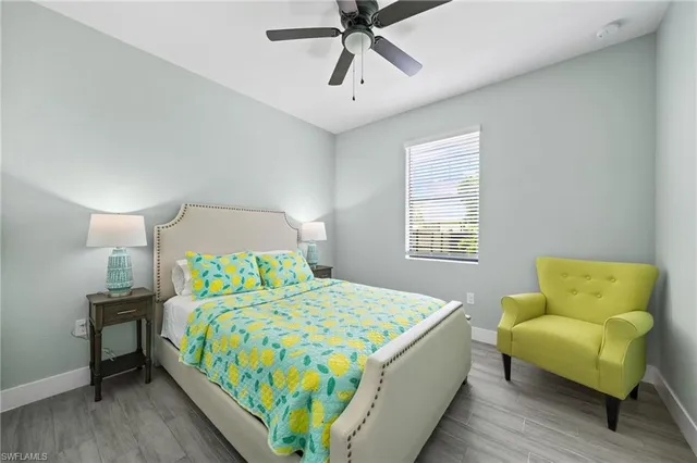 a bedroom with a bed a couch and a window