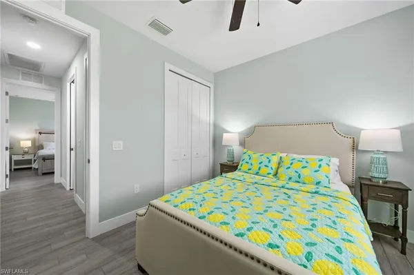 a bedroom with a bed and a chandelier