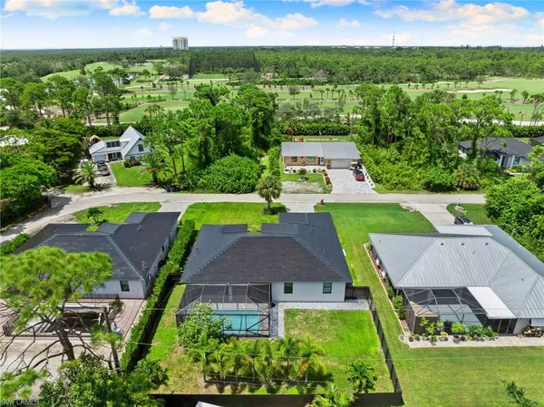 an aerial view of residential houses with outdoor space and street view