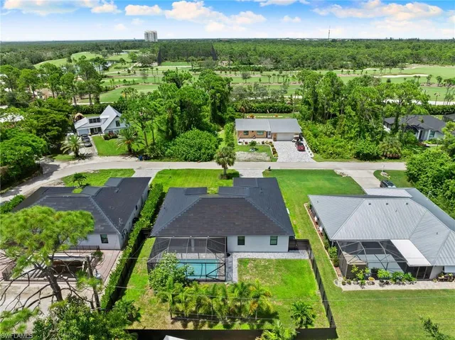 an aerial view of residential houses with outdoor space and street view