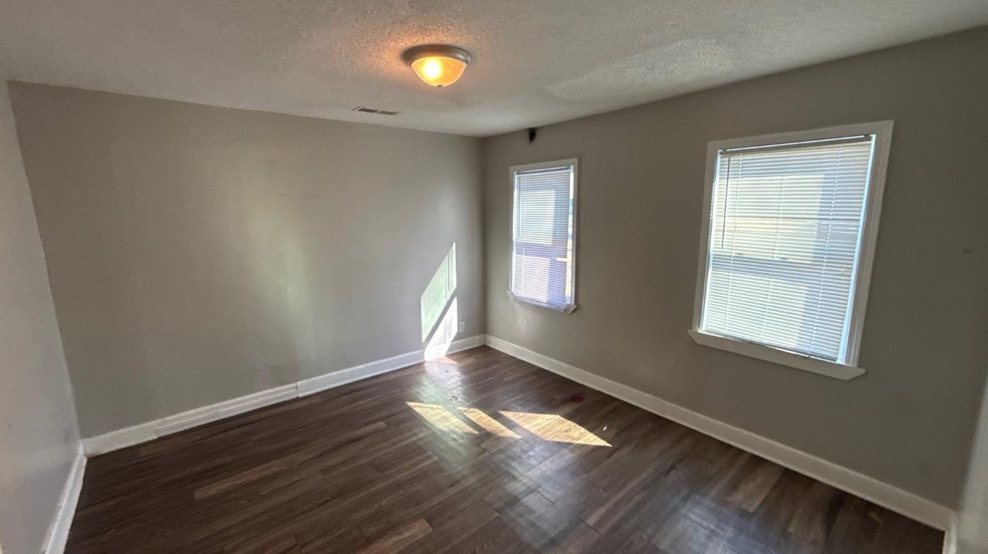 1311 Marlin Road Memphis, TN 38116 - Photo 3 of 4 Empty room featuring a textured ceiling and dark wood-style floors