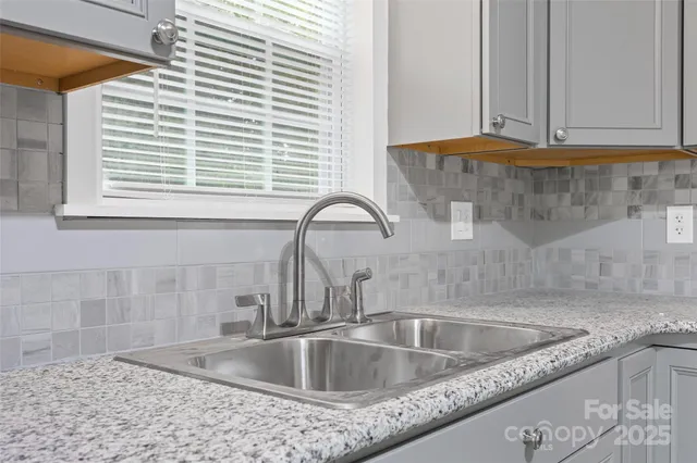 a kitchen with sink and window