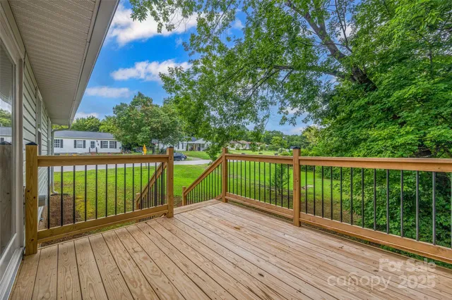 a view of balcony with wooden floor and fence