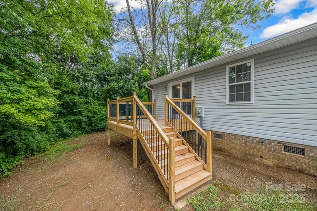 a view of a house with a yard and deck