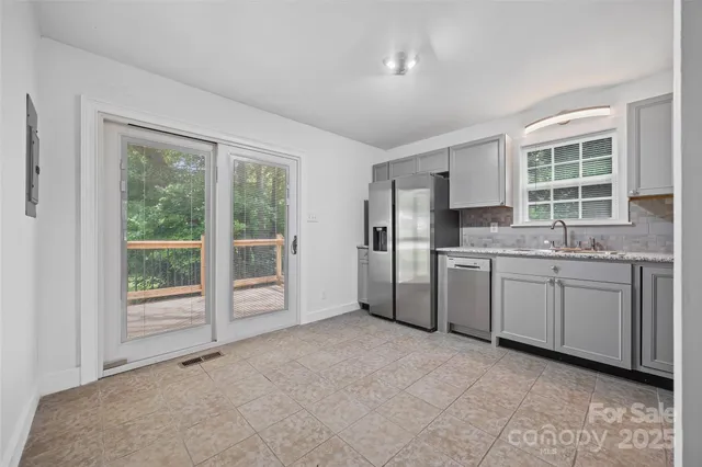 a kitchen with a sink window and cabinets