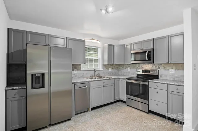 a kitchen with a sink stainless steel appliances and cabinets