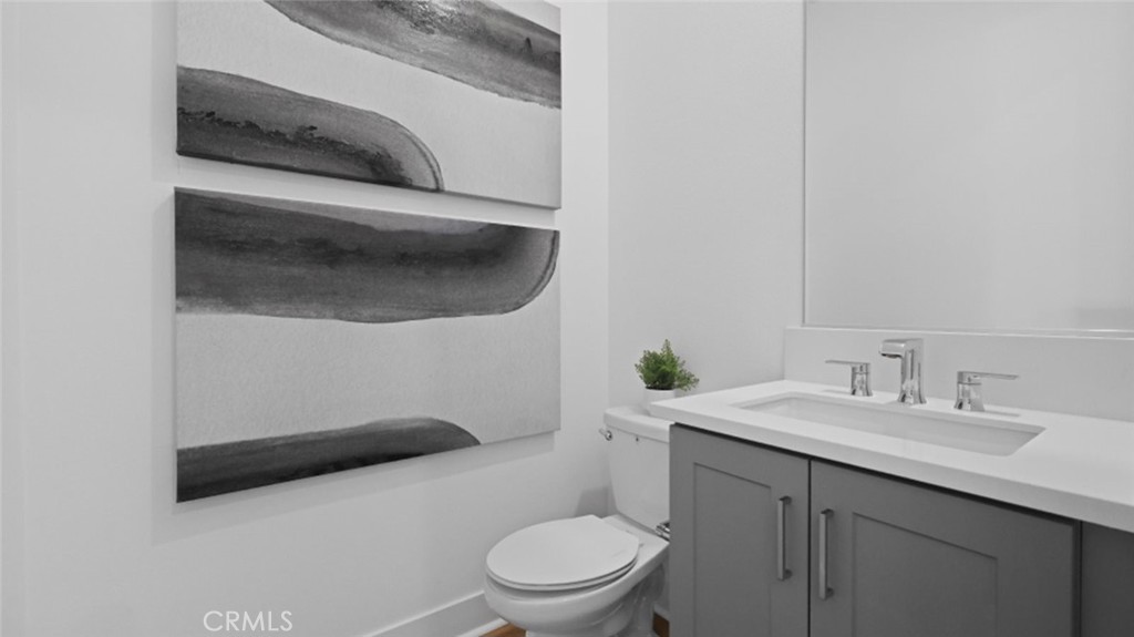 29602 Paseo Tranquilo Valencia, CA 91354 - Photo 14 of 43 a bathroom with a sink a toilet and a mirror