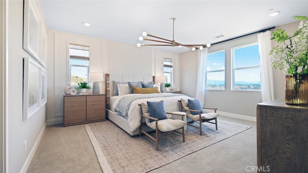 29602 Paseo Tranquilo Valencia, CA 91354 - Photo 20 of 43 a bedroom with a bed and a chandelier