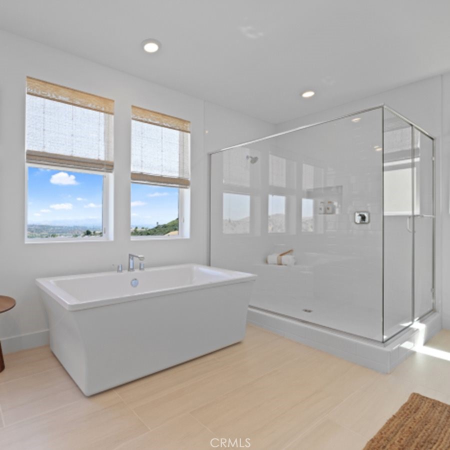 29602 Paseo Tranquilo Valencia, CA 91354 - Photo 23 of 43 a spacious bathroom with a bathtub and a shower