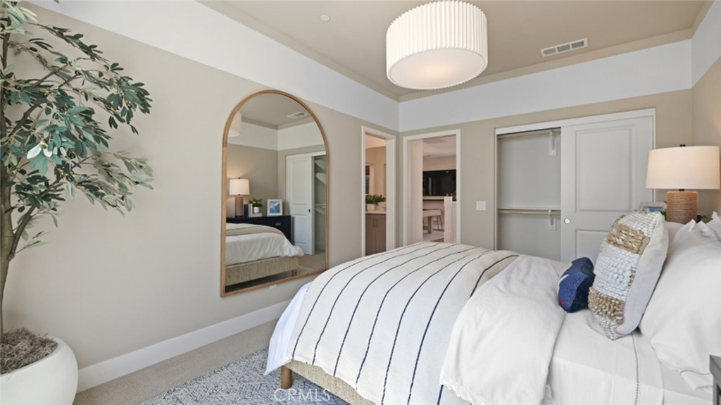 29602 Paseo Tranquilo Valencia, CA 91354 - Photo 31 of 43 a bedroom with a bed and a chandelier