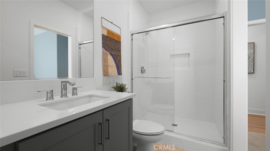 29602 Paseo Tranquilo Valencia, CA 91354 - Photo 32 of 43 a bathroom with a shower sink vanity mirror and toilet
