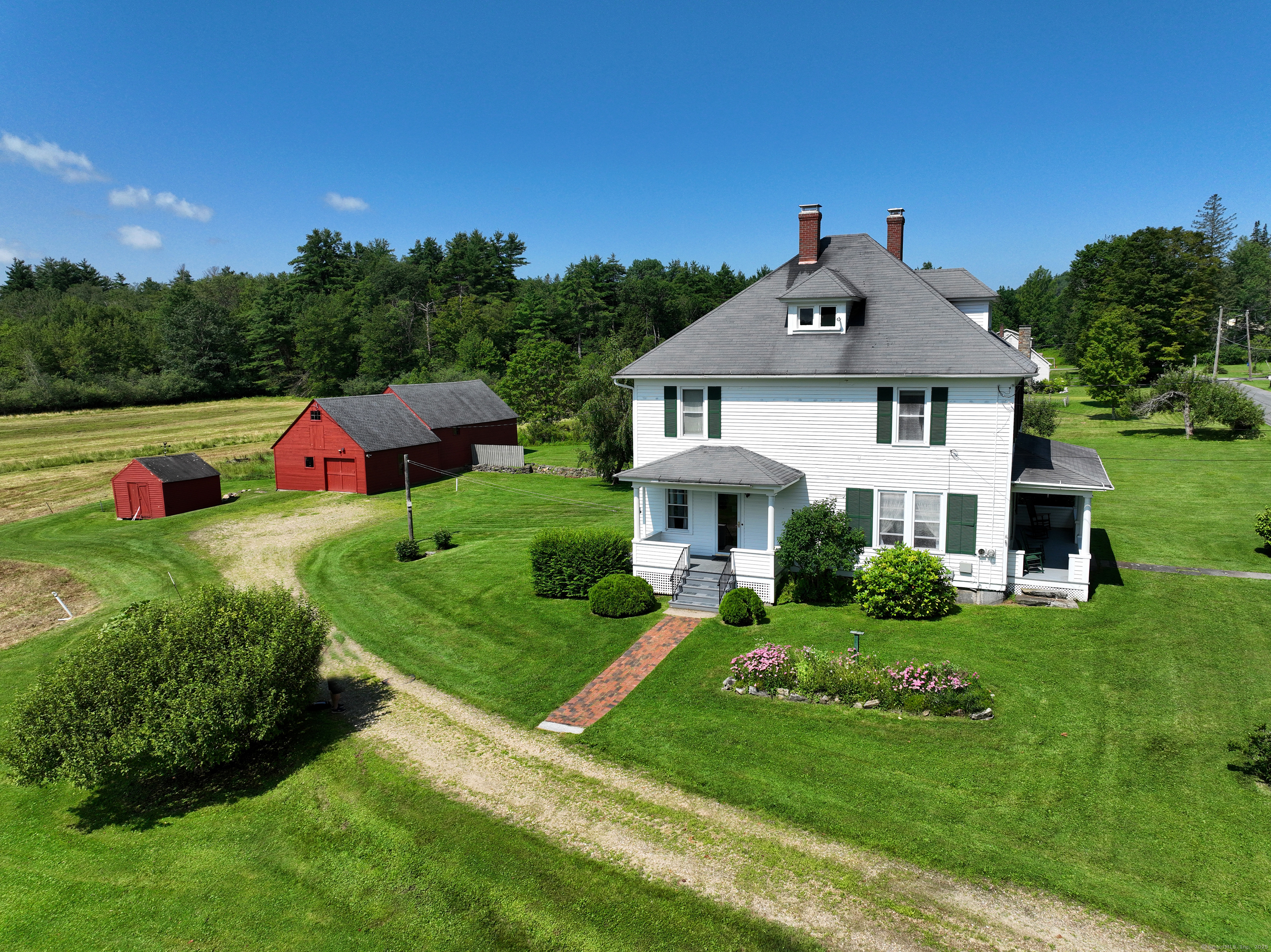 a front view of a house with yard and green space