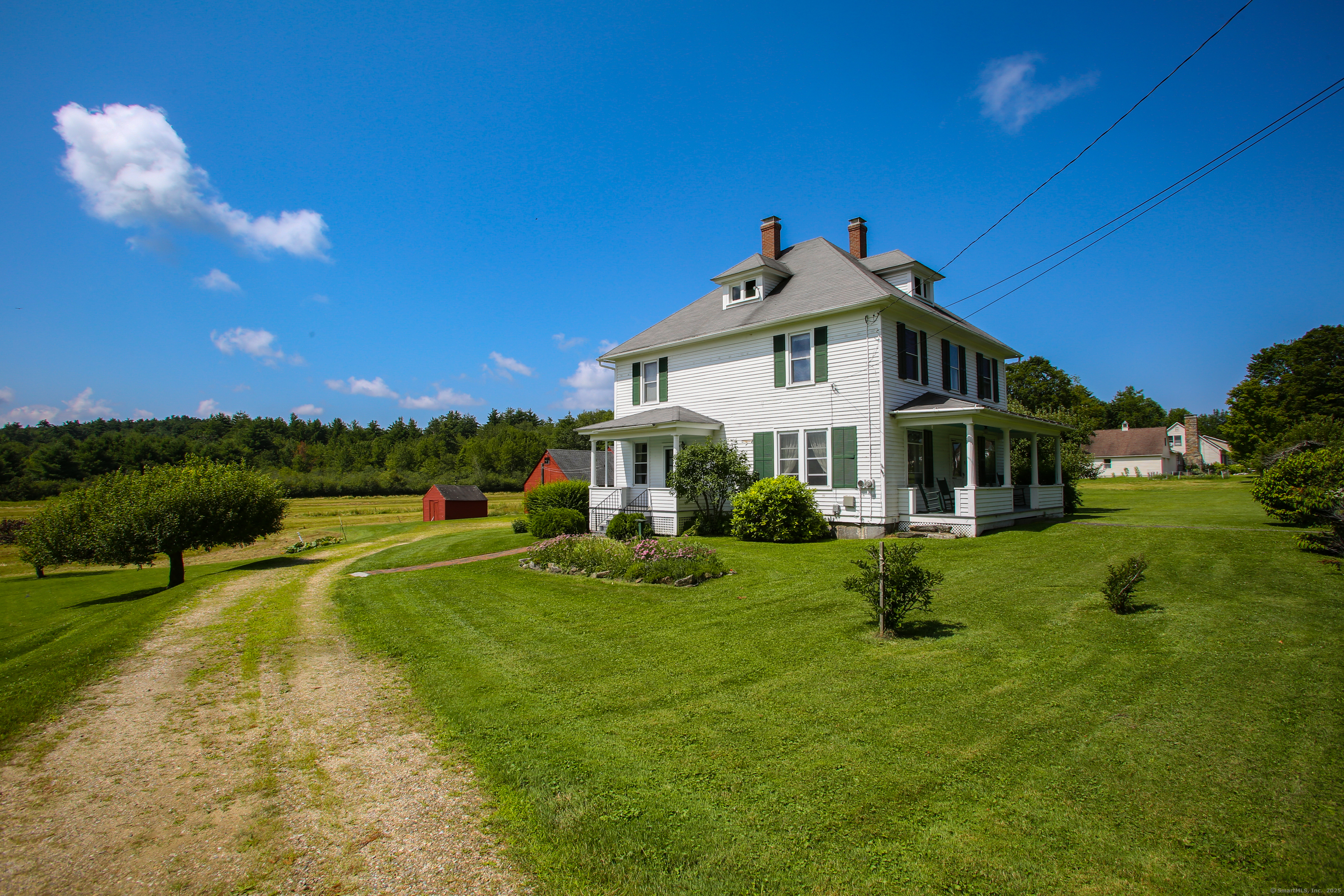 31 Sunset Ridge Road Norfolk, CT 06058 - Photo 20 of 33 a yellow and red house with a big yard and big trees