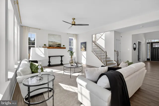 a dining room with furniture and wooden floor