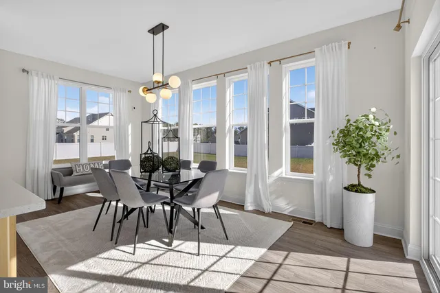 a living room with furniture a rug and a window