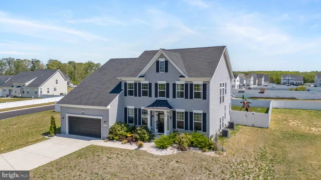 a view of a hallway with wooden floor windows and a livingroom