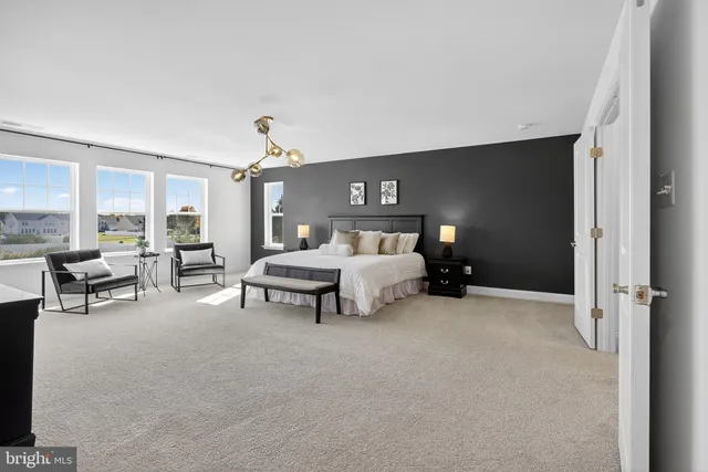 a spacious bedroom with a bed and a couch