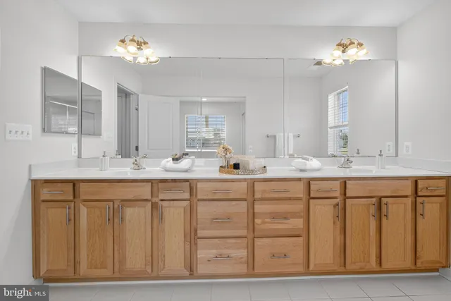 a spacious bedroom with a bed and a large window