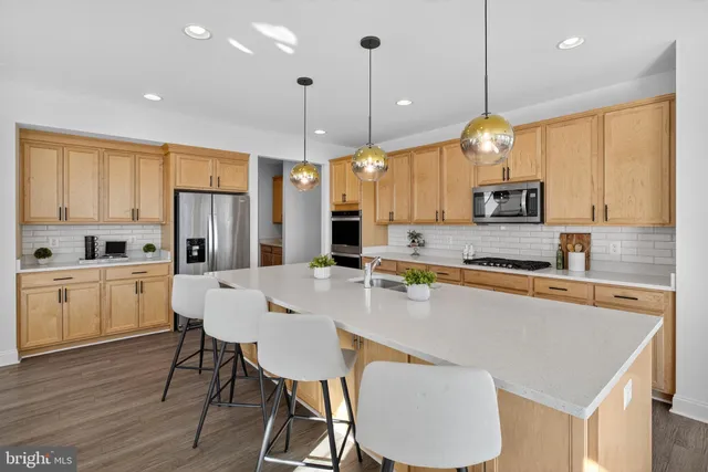 a kitchen with stainless steel appliances a refrigerator sink and cabinets