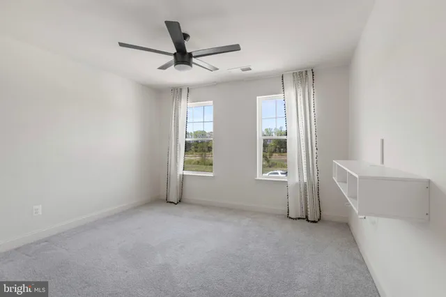 a view of a big house with a big yard and large tree