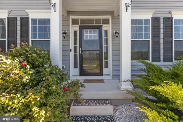 an aerial view of a house with a garden and lake view