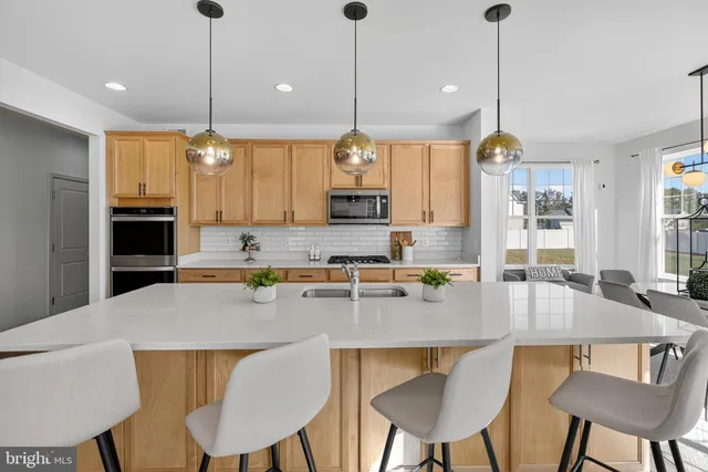 a large kitchen with kitchen island a large island in it