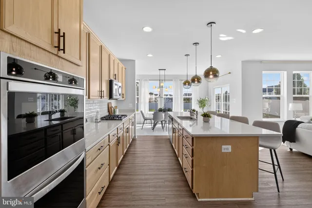 a large kitchen with a table and chairs