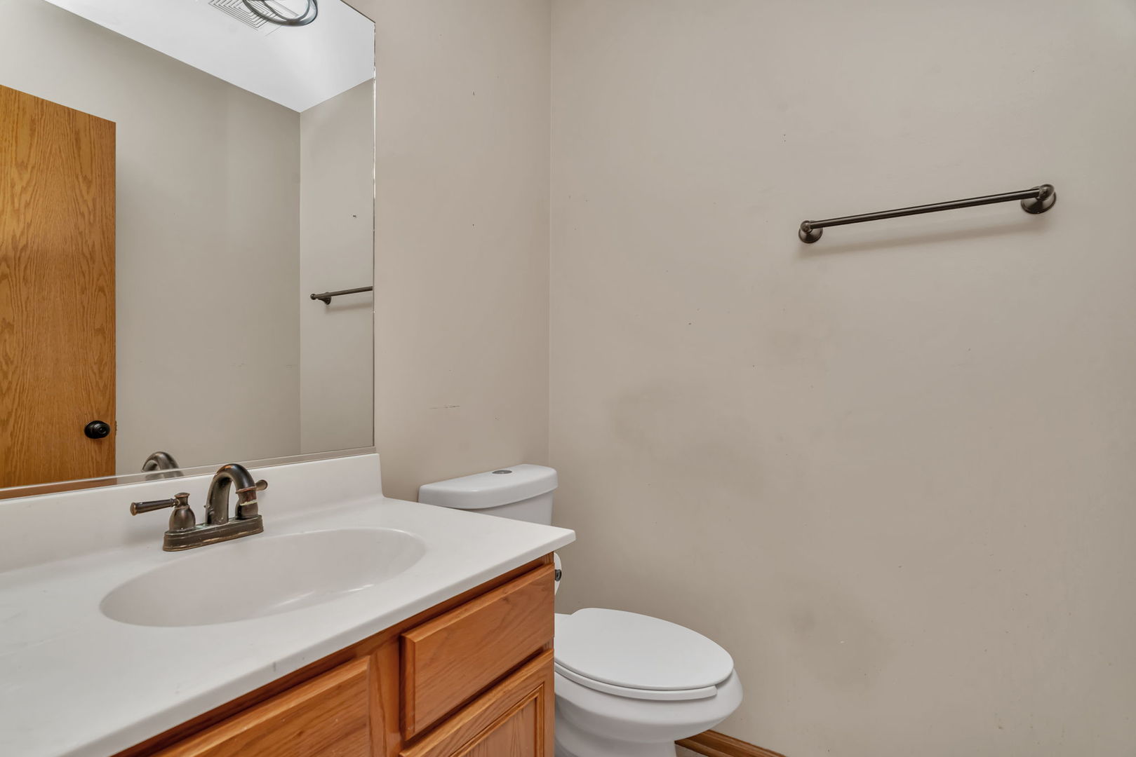 936 Treeline Court Lockport, IL 60441 - Photo 19 of 33 a bathroom with a sink a toilet and mirror