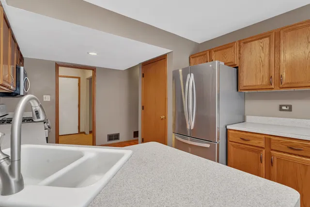 a kitchen with stainless steel appliances granite countertop a refrigerator and a sink