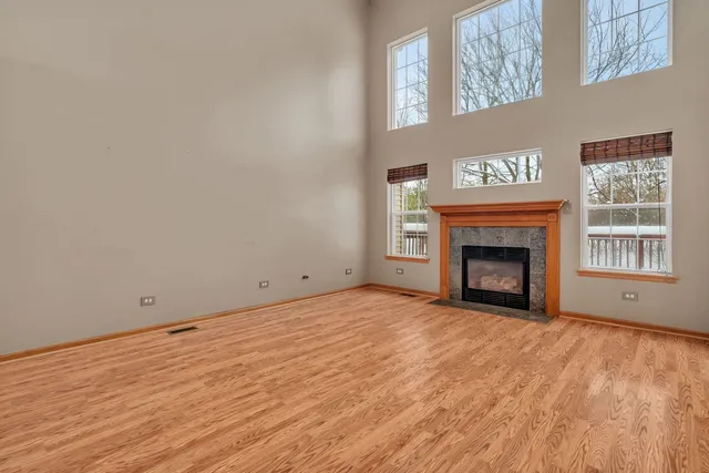 a view of empty room with a fireplace