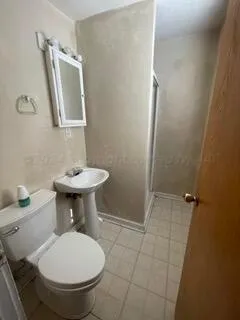 a bathroom with a sink toilet and a mirror