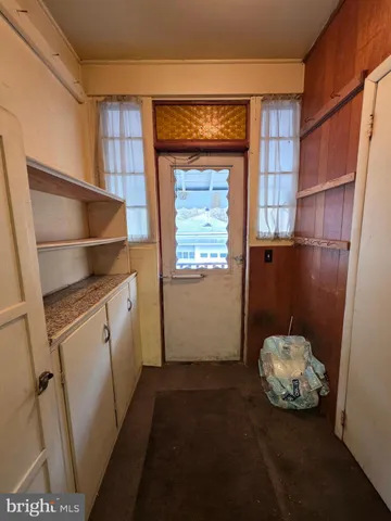 a view of a hallway and a livingroom with wooden floor