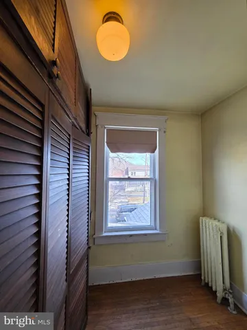 a view of a balcony with furniture and floor to ceiling window