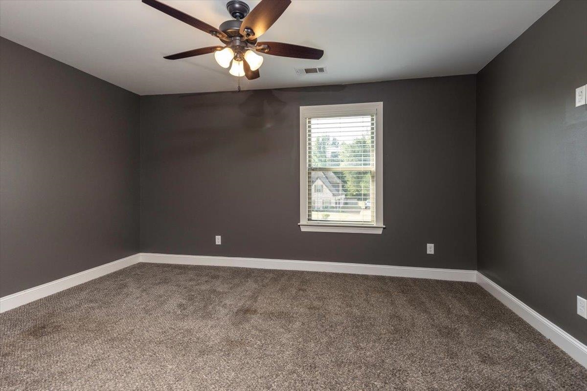 3328 Straw Bridge Road Olive Branch, MS 38654 - Photo 24 of 28 Carpeted room with dark gray walls, white trim, and a ceiling fan