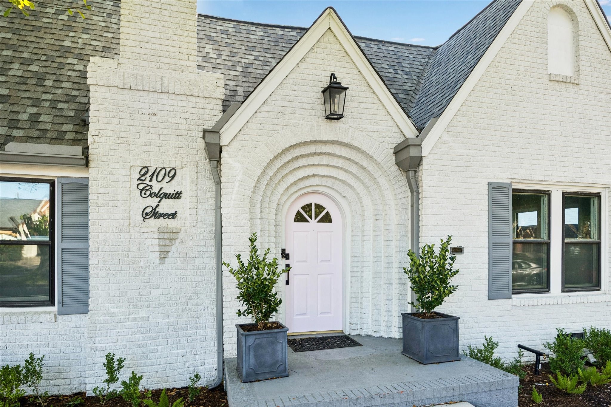 2109 Colquitt Street Houston, TX 77098 - Photo 2 of 28 A distinctive arched brick entry highlights the home’s architectural character, leading to a soft-toned front door and inviting covered stoop.