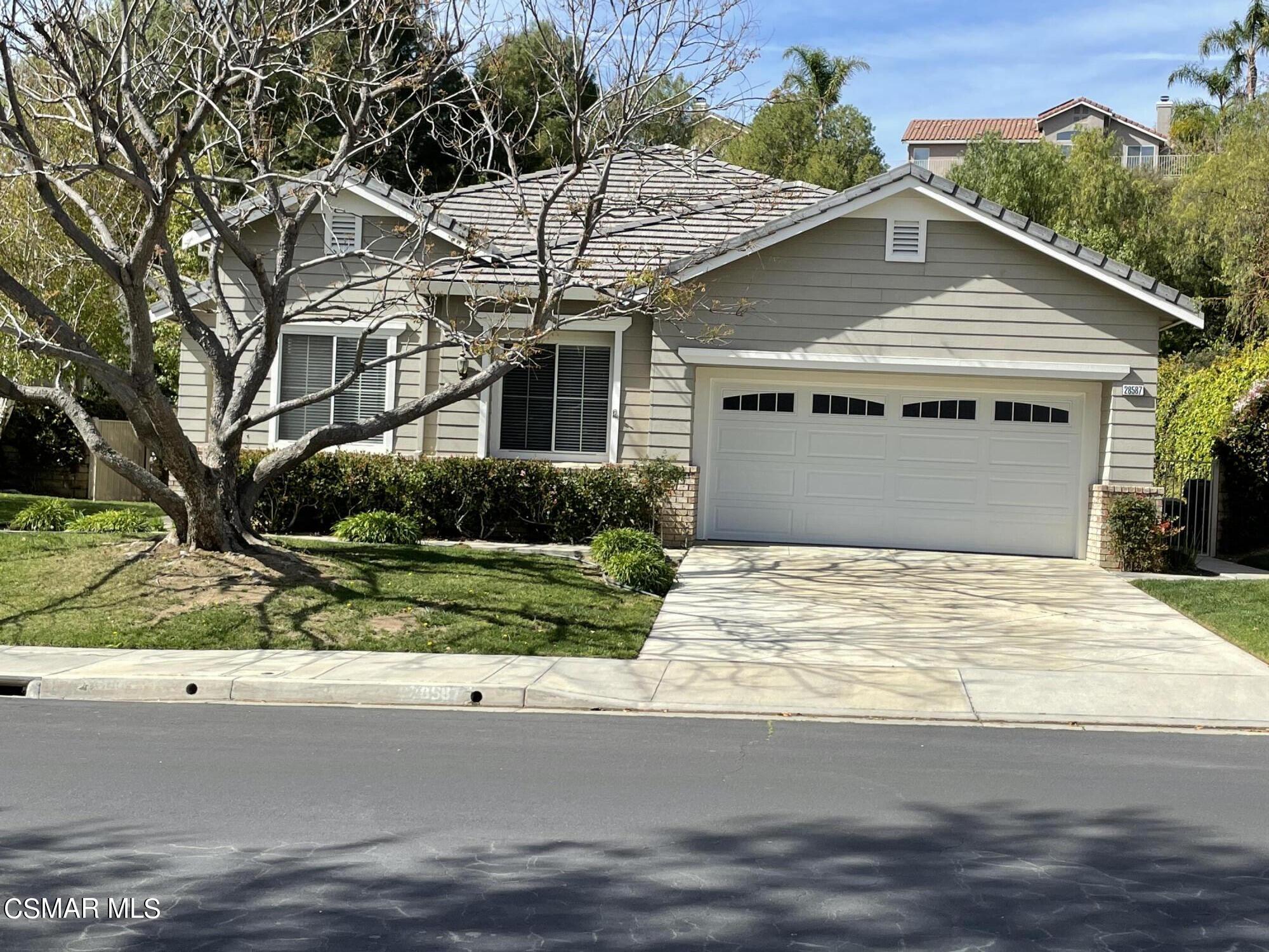 28587 Haskell Canyon Road Saugus, CA 91390 - Photo 1 of 26 a front view of a house with a yard and garage