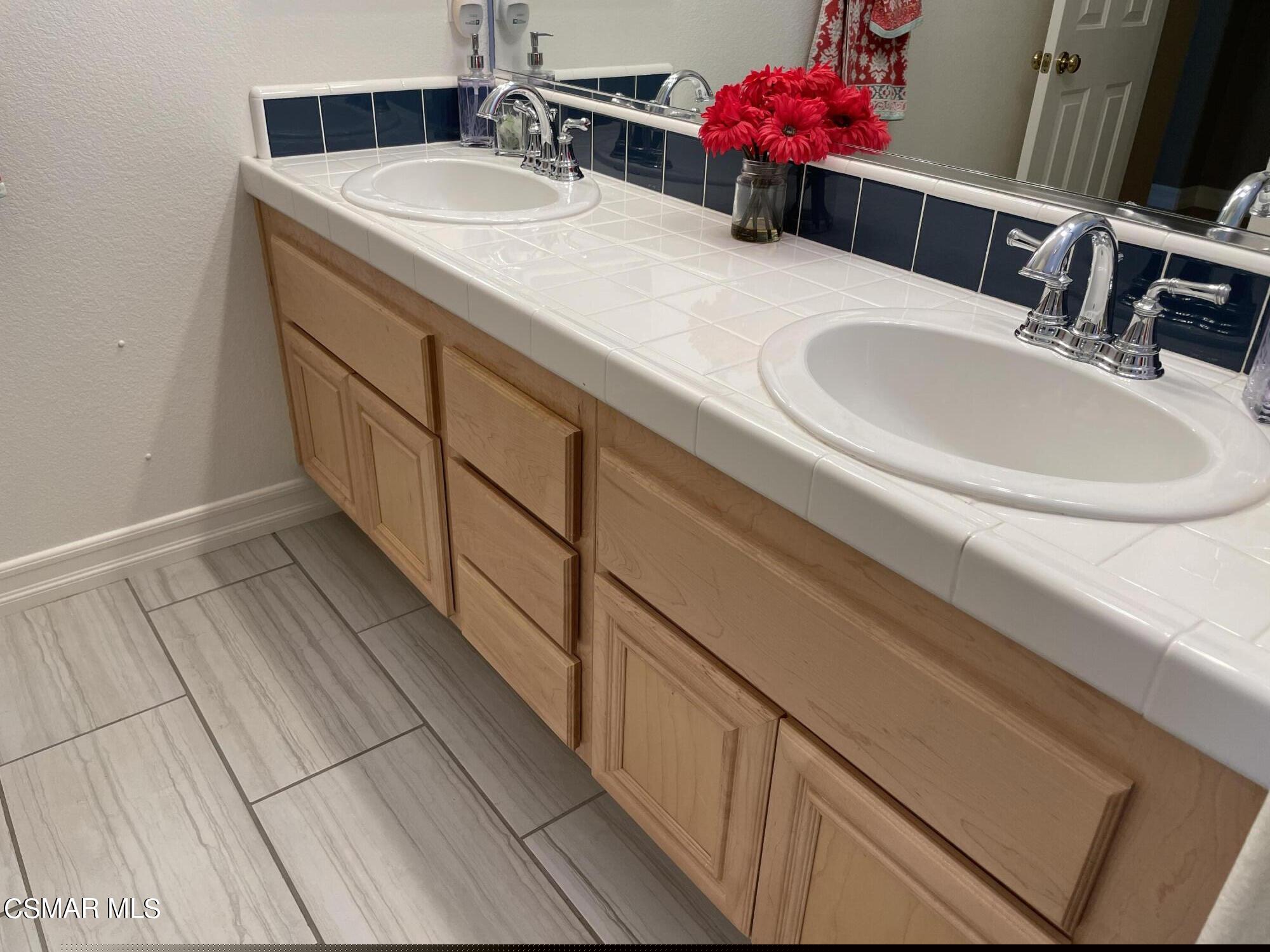 28587 Haskell Canyon Road Saugus, CA 91390 - Photo 19 of 26 a bathroom with a sink and a mirror