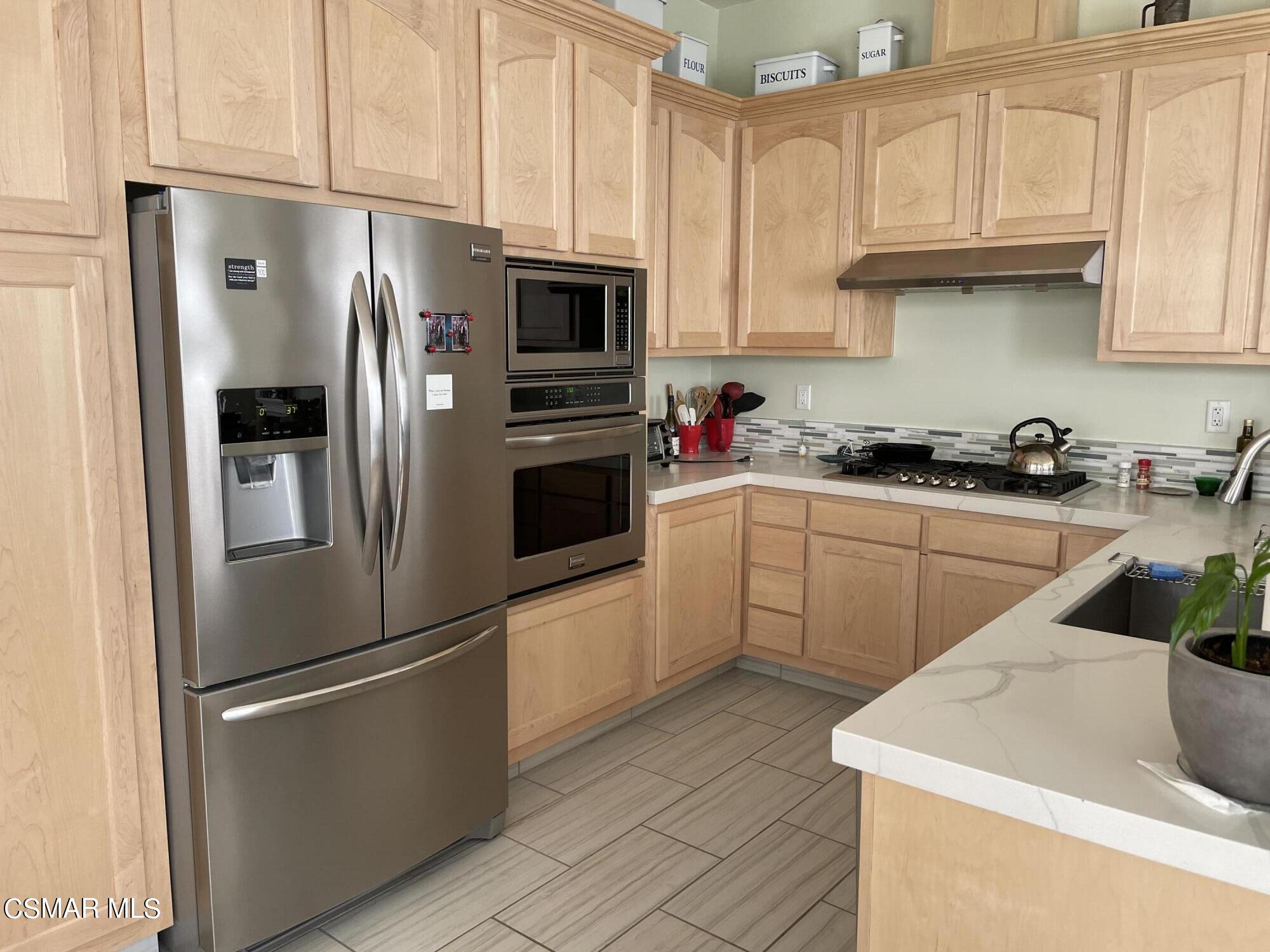 28587 Haskell Canyon Road Saugus, CA 91390 - Photo 6 of 26 a kitchen with stainless steel appliances a refrigerator sink and cabinets
