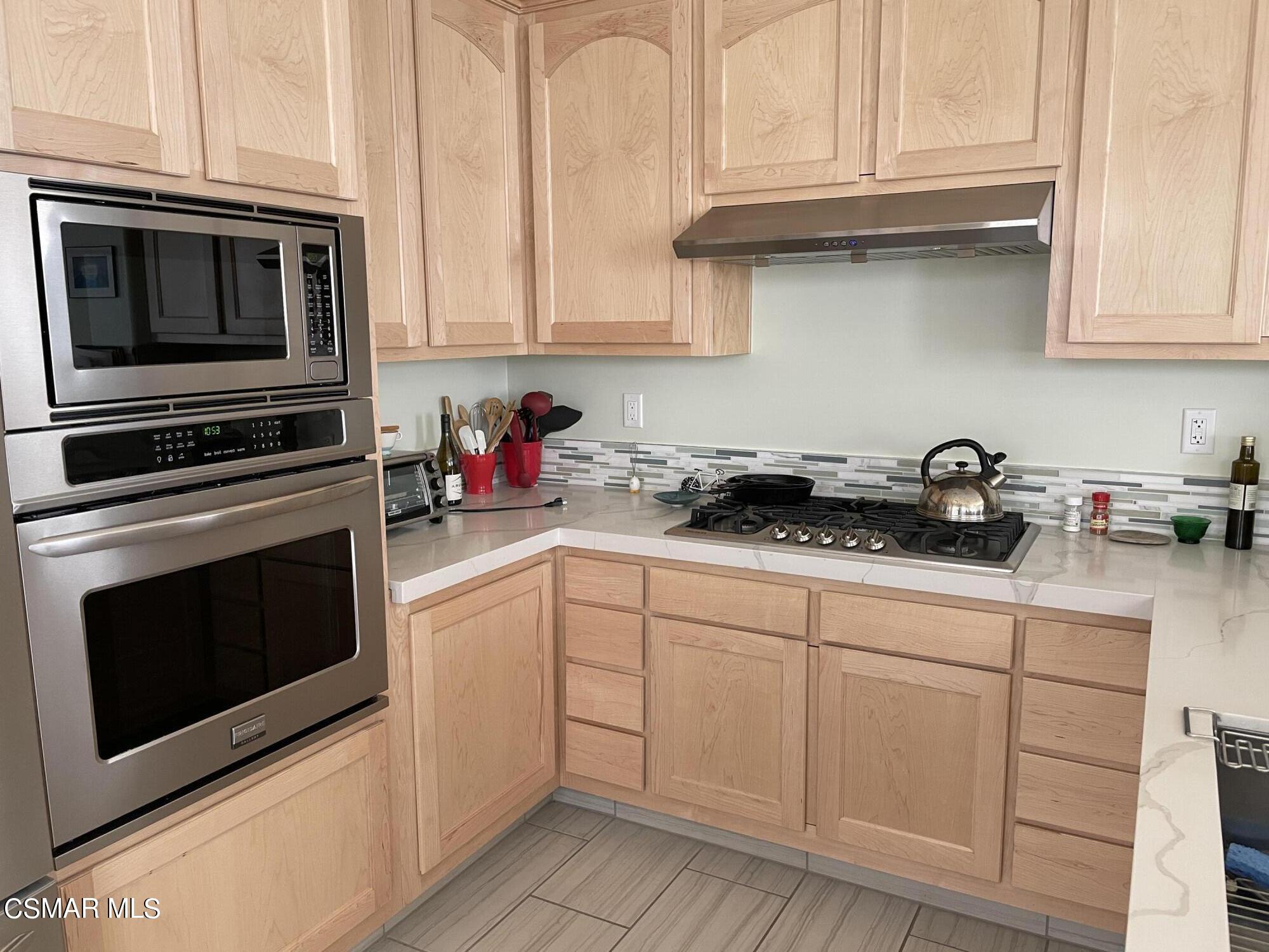 28587 Haskell Canyon Road Saugus, CA 91390 - Photo 9 of 26 a kitchen with white cabinets stainless steel appliances and sink